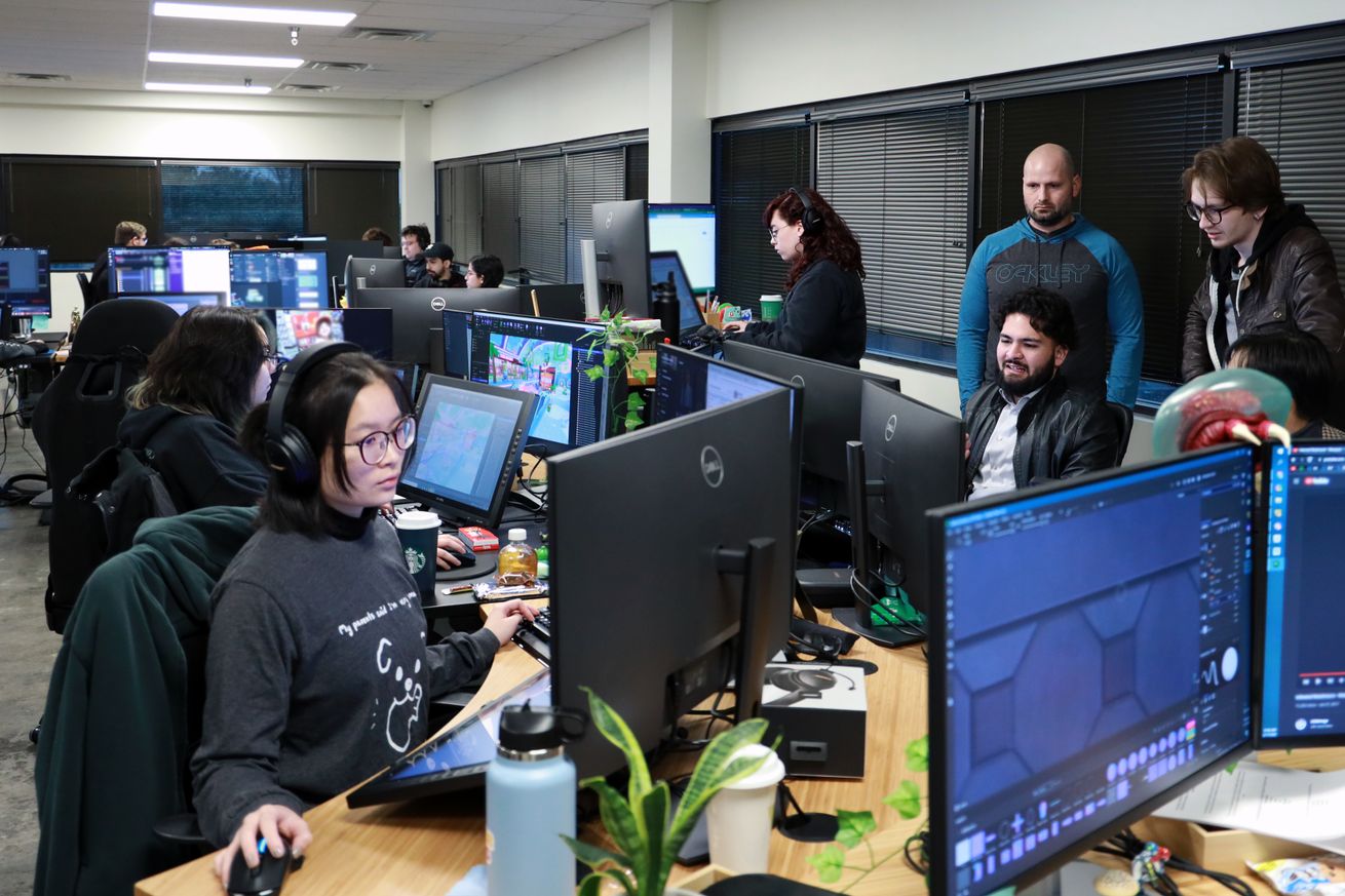 Group image of all our Wonder Workers in front of their computers inside our office.