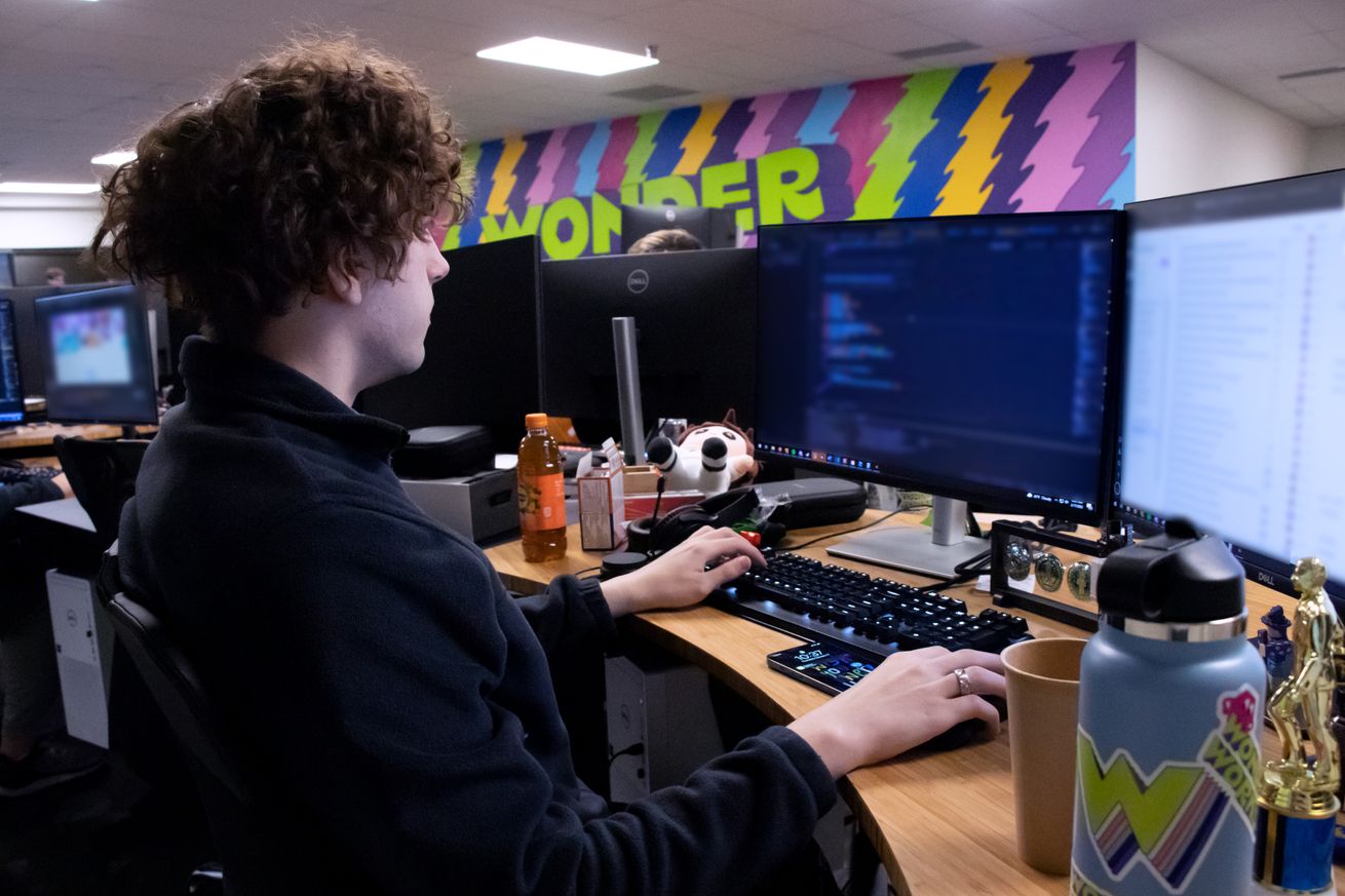 Image of Josh in front of his computer, coding some games.