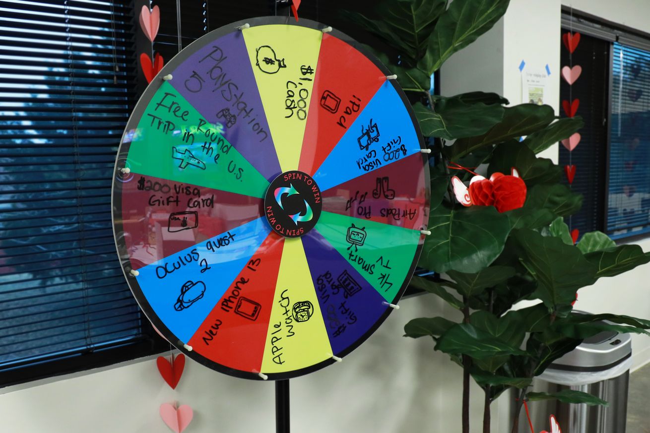 Image of a spin to win wheel, featuring a bunch of available rewards for employees.