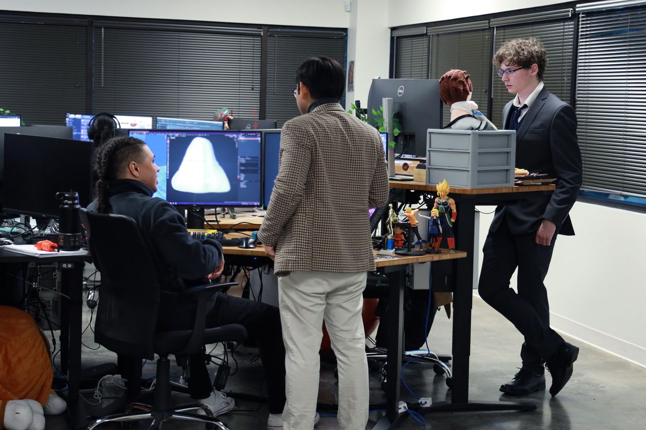 Group image of members of the Wonder Works team by their desks.